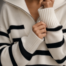 Sueter Tricot Feminino Listrado Navy com Zíper Anabeaz
Suéter com Zíper, Tricot Listrado Navy, Blusa Gola Alta com Zíper, Suéter Canelado Grosso, Tricô Half Zip, Blusa Mariniere Feminina, Suéter de Luxo Listrado, Anabeaz, Inverno 2026, Moda Preppy Luxo
Detalhe aproximado do zíper de metal escovado e da textura canelada densa do suéter navy Anabeaz